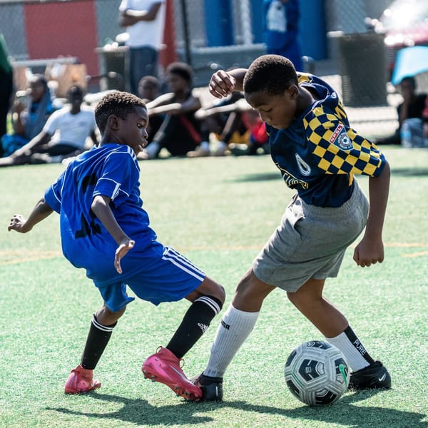 Youth soccer players shaking hands after a match