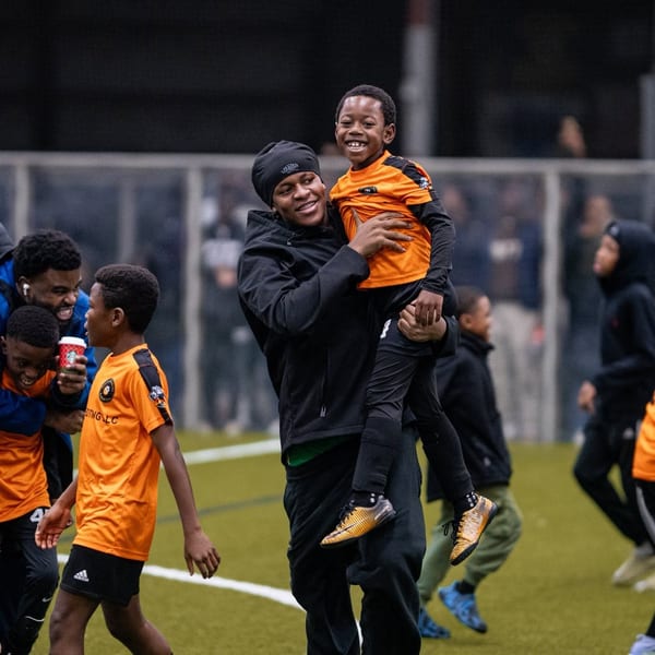 Coach mentoring youth players on the field