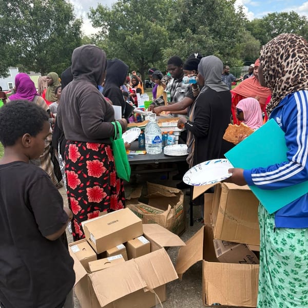 Volunteers sorting and packing school supply boxes