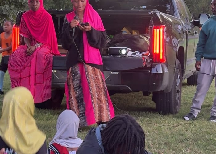 Diverse families laughing and talking together at a community dinner