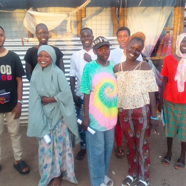 Women in a community empowerment workshop learning new skills together