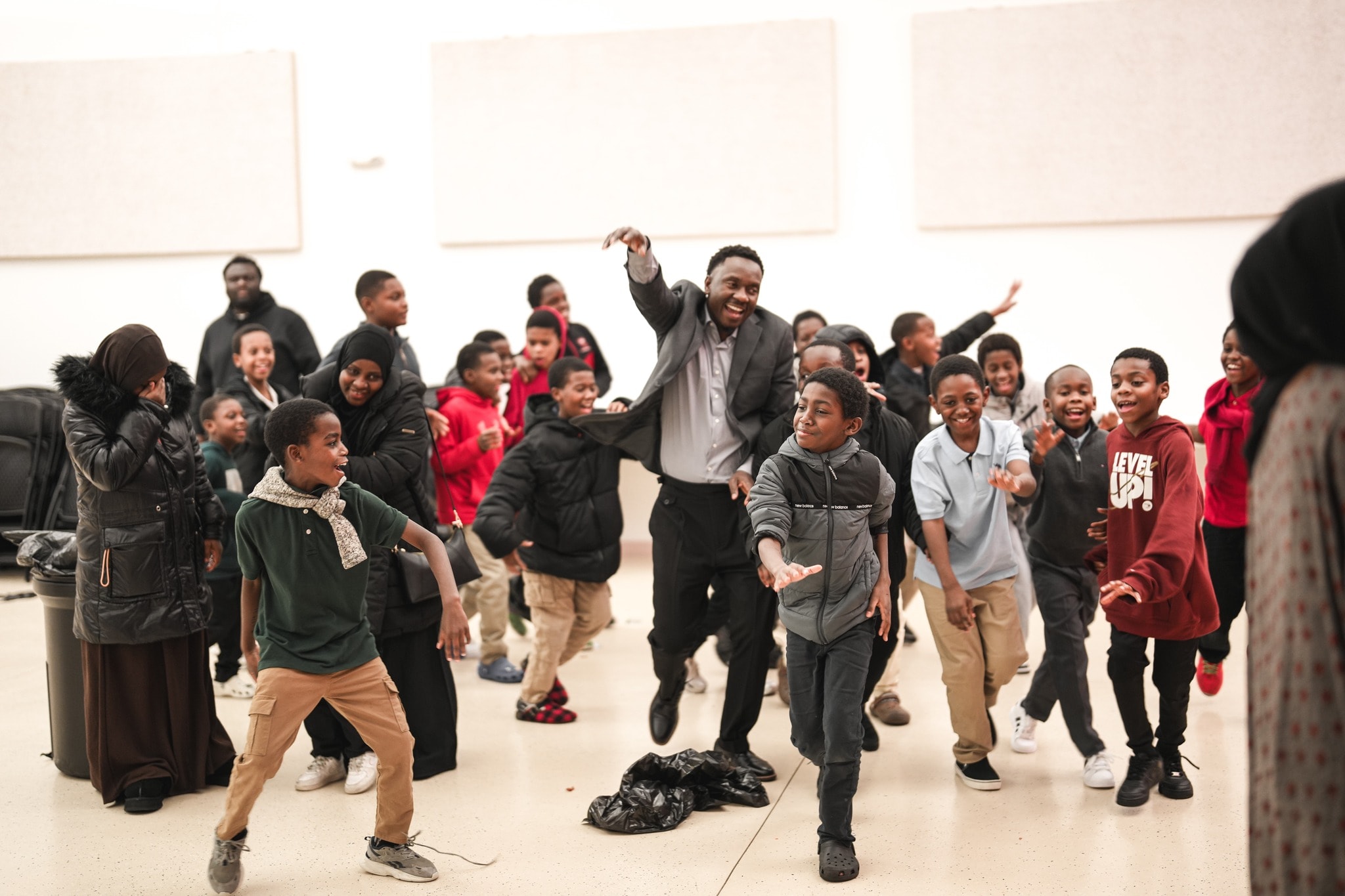 Man leading children in a joyful celebration
