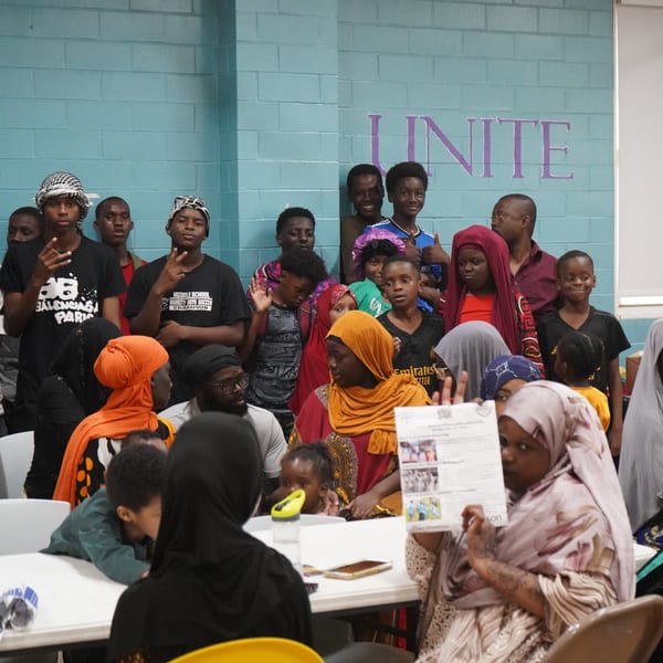 A family together at home, safe and belonging in their community