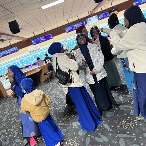 Women and children together at a bowling alley