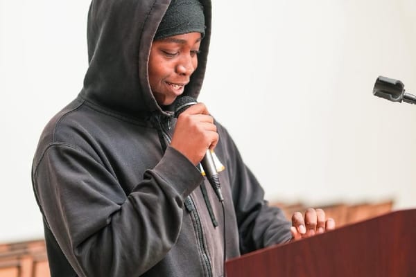 Young person speaking confidently at community event