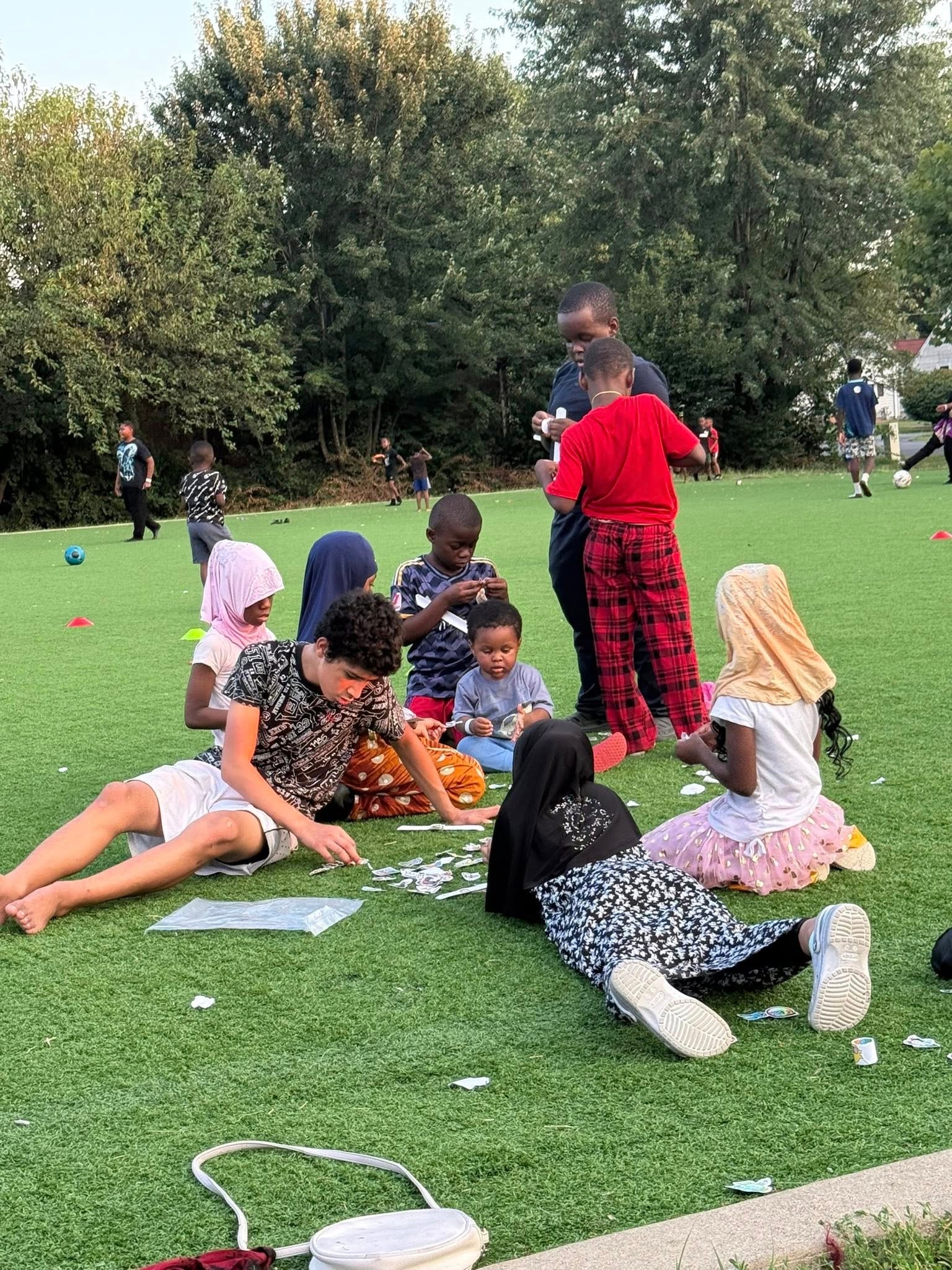 Children playing games on a grassy field