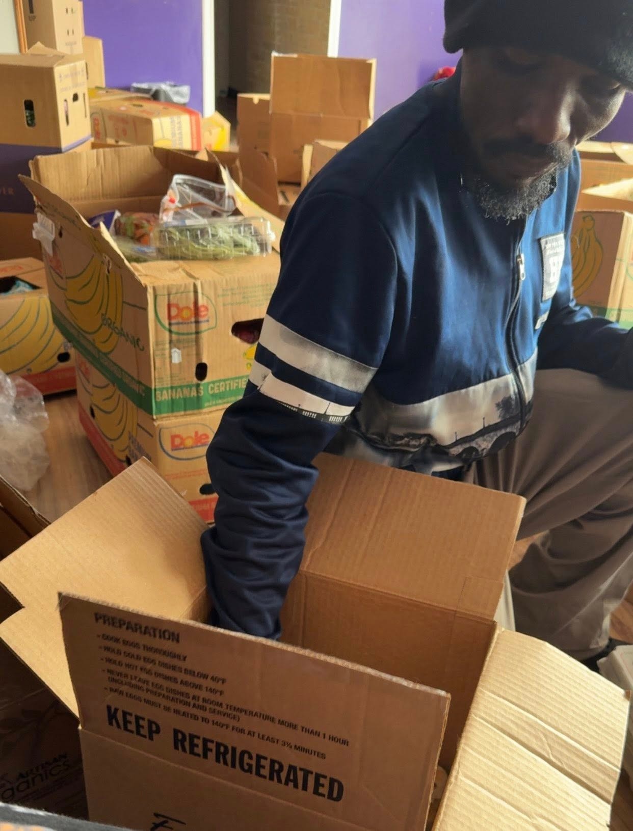 Worker organizing refrigerated shipment boxes