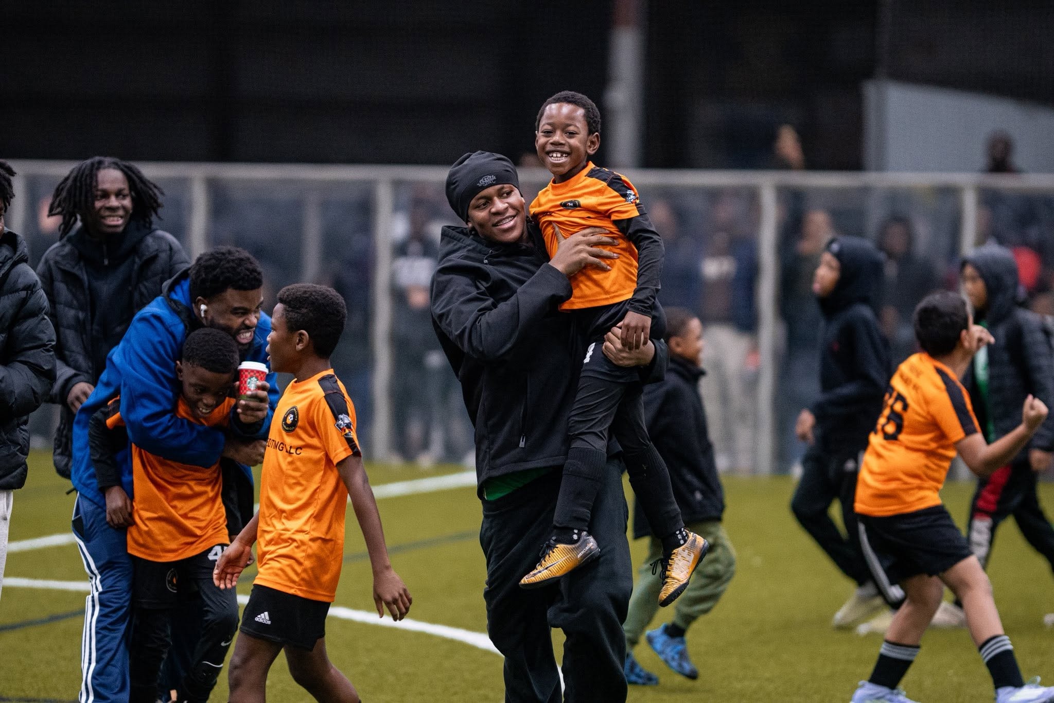 Youth soccer team celebrating with families