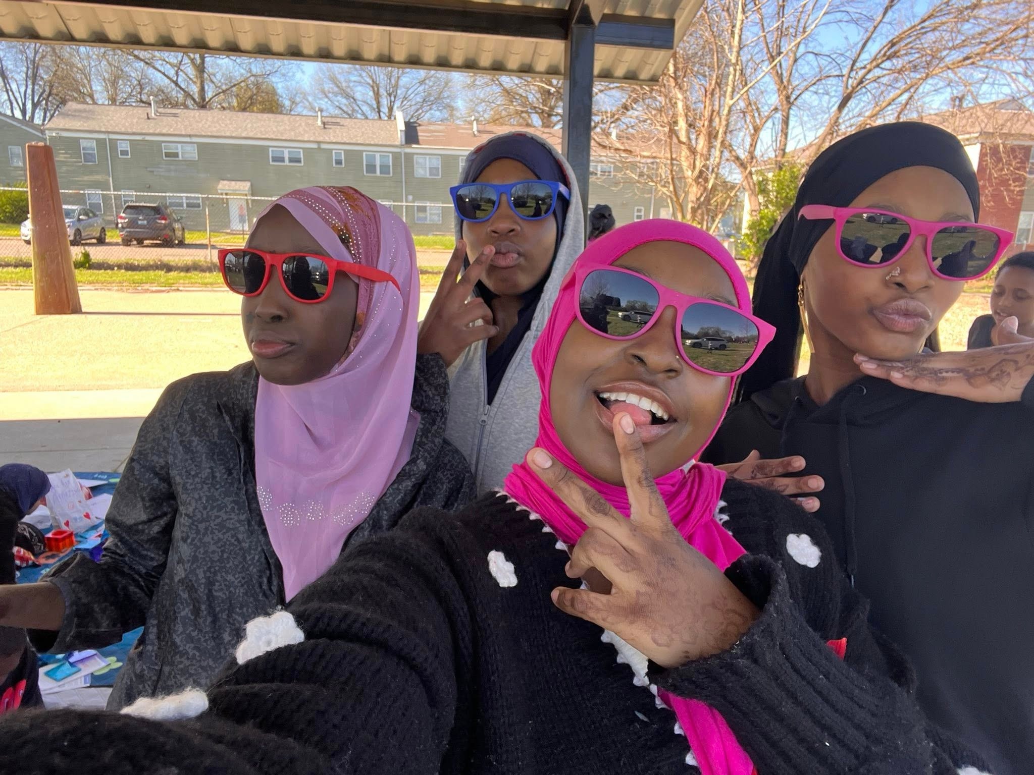 Group of women wearing colorful sunglasses outdoors