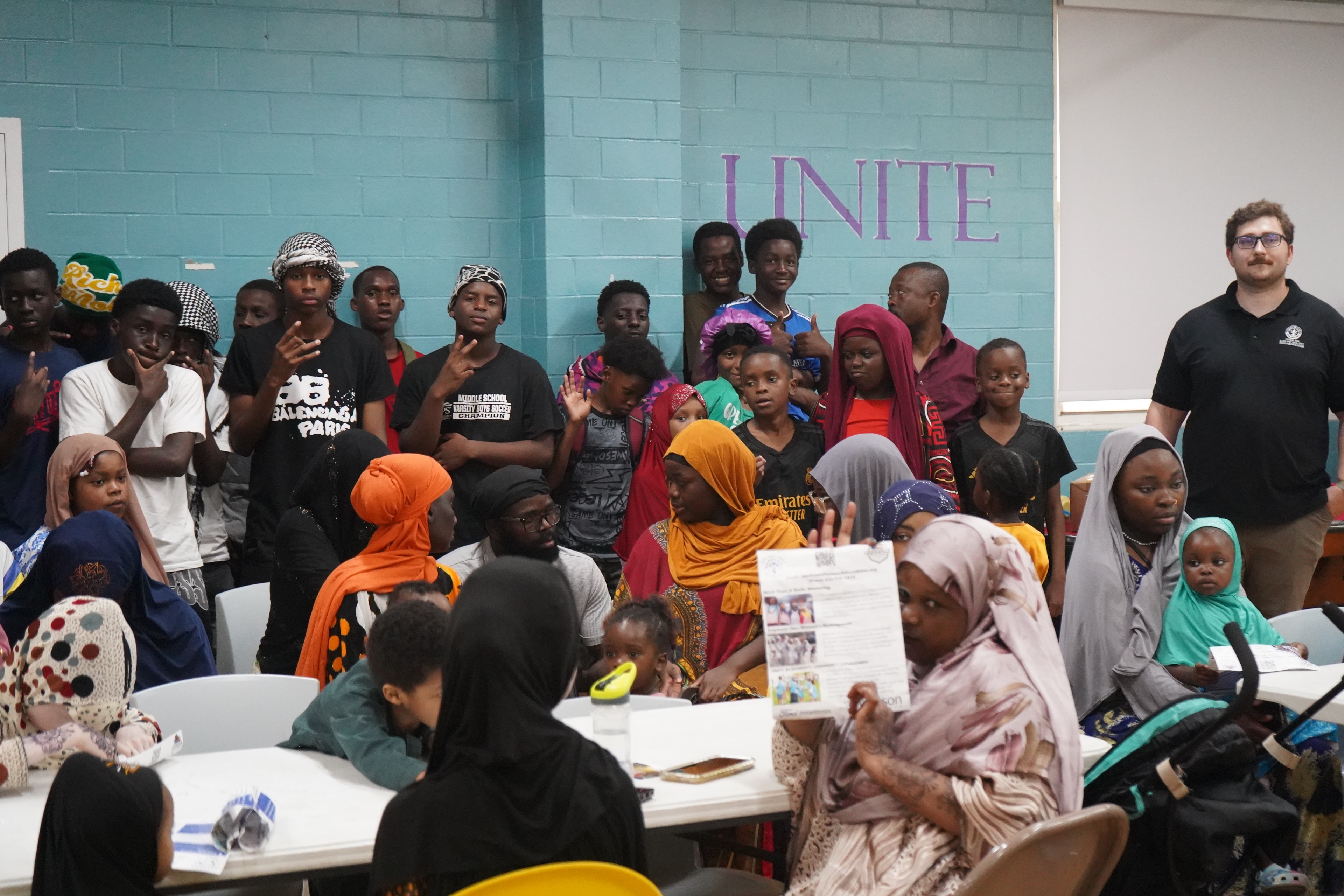 Diverse group gathered in a classroom community event