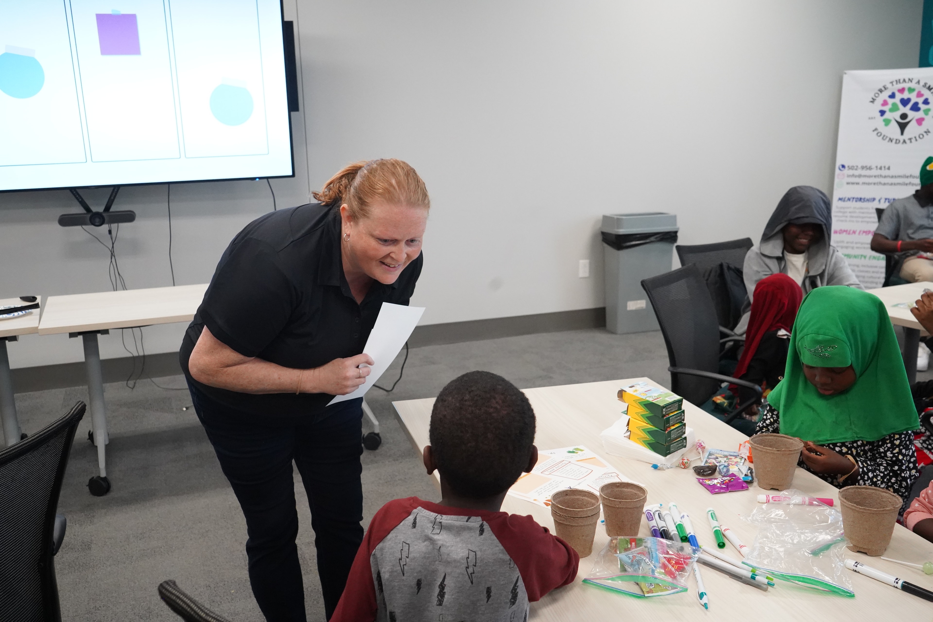 Woman leading a children’s craft activity