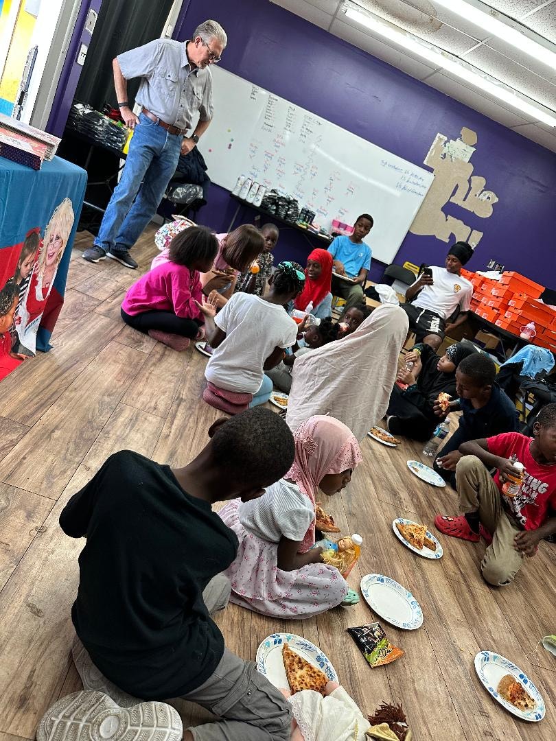 Teacher leading a classroom meal gathering