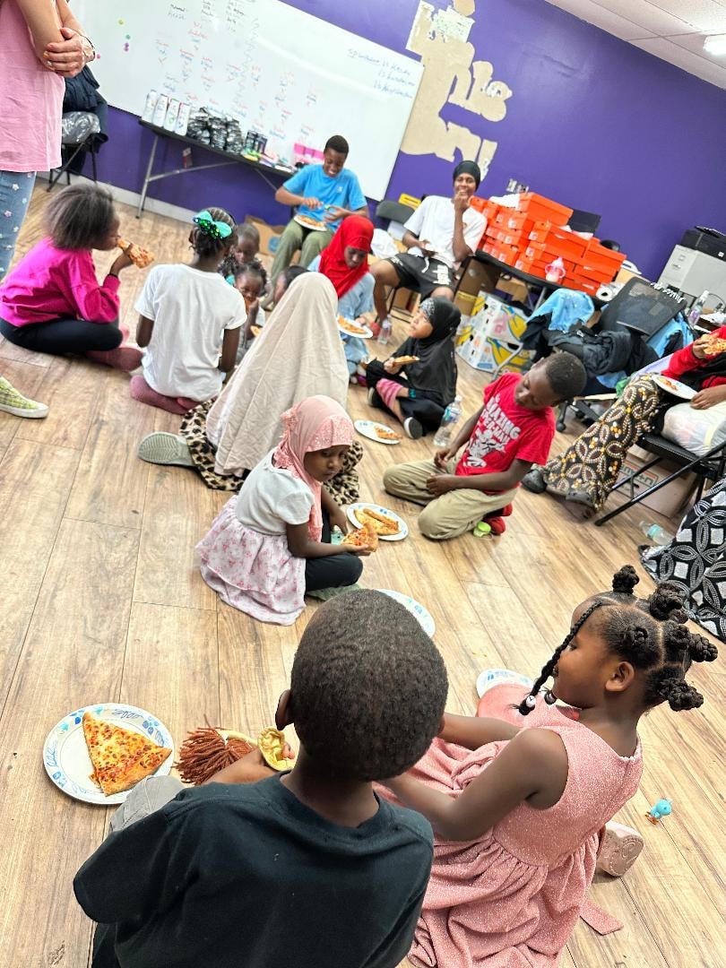 Children eating pizza at a community gathering