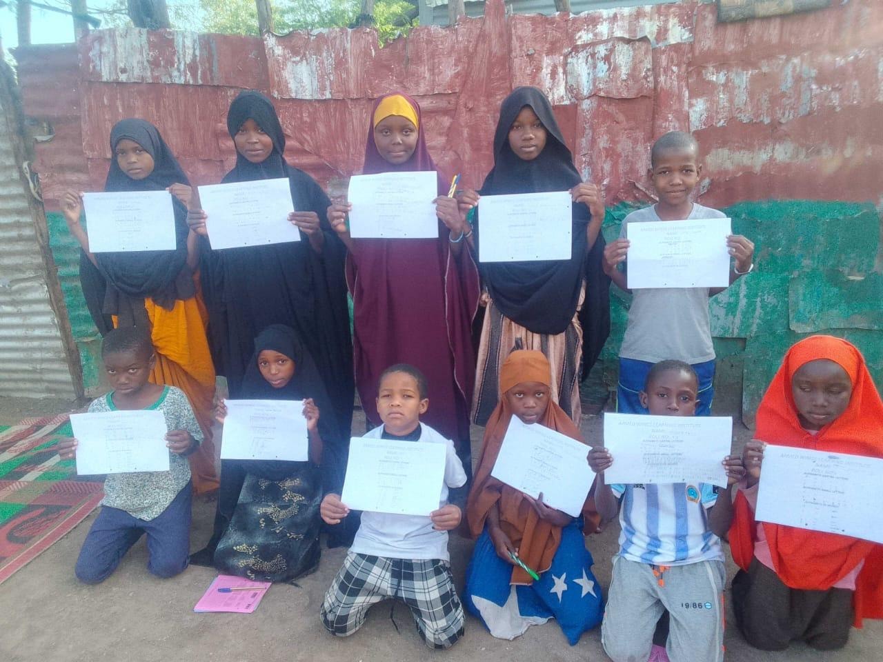 Children displaying school certificates together